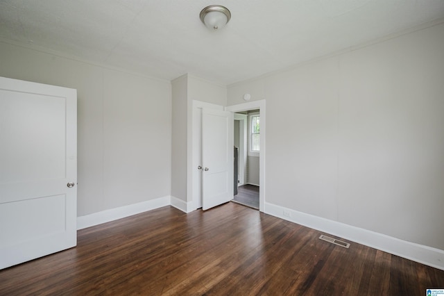 unfurnished room with wood finished floors and baseboards