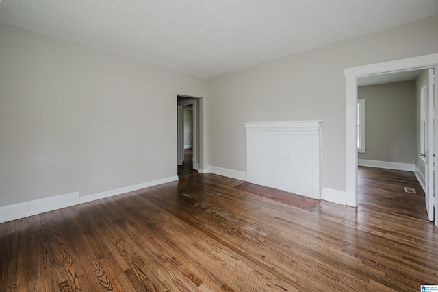 spare room with wood finished floors and baseboards