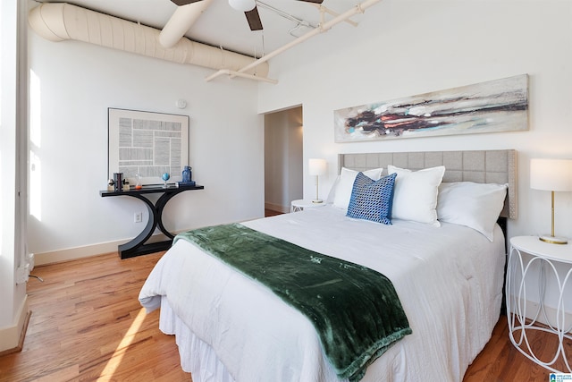 bedroom featuring wood finished floors and baseboards