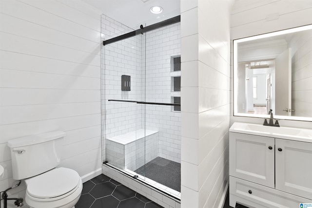 full bath with a stall shower, toilet, vanity, tile patterned flooring, and crown molding