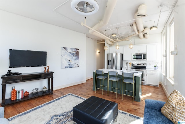 living room with light wood finished floors and baseboards