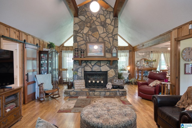 179 Idlewood Cir, Alexandria, AL 36250 - living area featuring a ceiling fan, beamed ceiling, wood finished floors, wood walls, and high vaulted ceiling