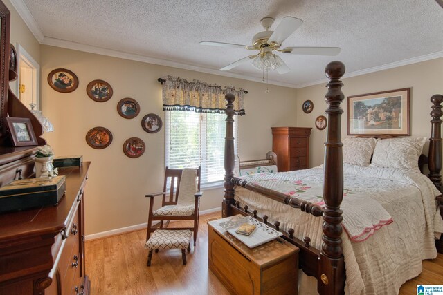 179 Idlewood Cir, Alexandria, AL 36250 - bedroom featuring light wood-style floors, a textured ceiling, ornamental molding, baseboards, and a ceiling fan