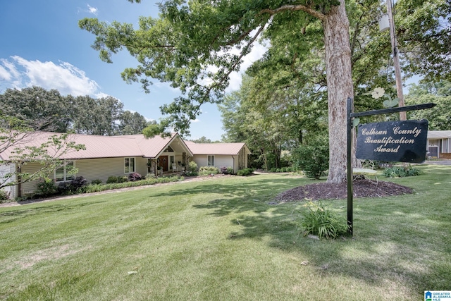 179 Idlewood Cir, Alexandria, AL 36250 - view of front of home featuring a front lawn, metal roof, and an attached garage