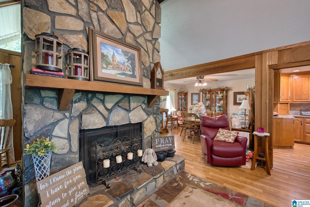 179 Idlewood Cir, Alexandria, AL 36250 - living room featuring wood finished floors, a stone fireplace, ceiling fan, and vaulted ceiling