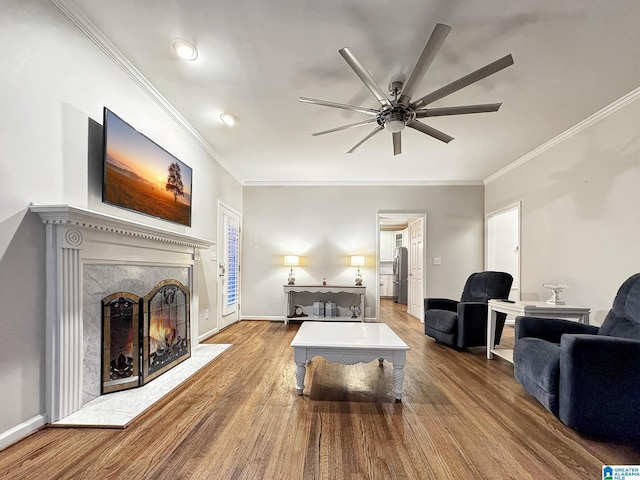 1851 Russet Woods Ln, Hoover, AL 35244 - living room featuring wood finished floors, a ceiling fan, ornamental molding, a fireplace, and baseboards