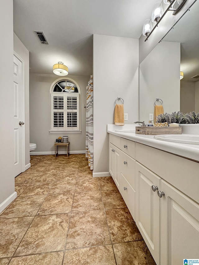 1851 Russet Woods Ln, Hoover, AL 35244 - bathroom with toilet, vanity, and baseboards