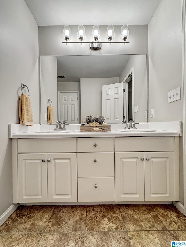 1851 Russet Woods Ln, Hoover, AL 35244 - bathroom featuring baseboards, double vanity, and stone finish floors
