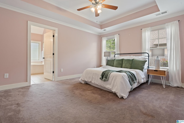 142 Falling Waters Ln, Maylene, AL 35114 - bedroom featuring ornamental molding, light colored carpet, a tray ceiling, baseboards, and connected bathroom