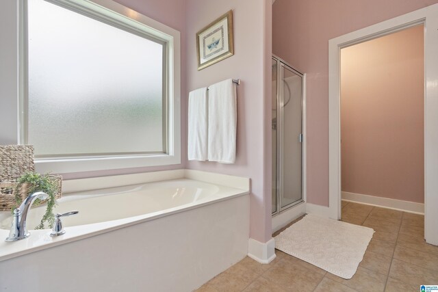 142 Falling Waters Ln, Maylene, AL 35114 - bathroom featuring a shower stall, tile patterned floors, a bath, and baseboards