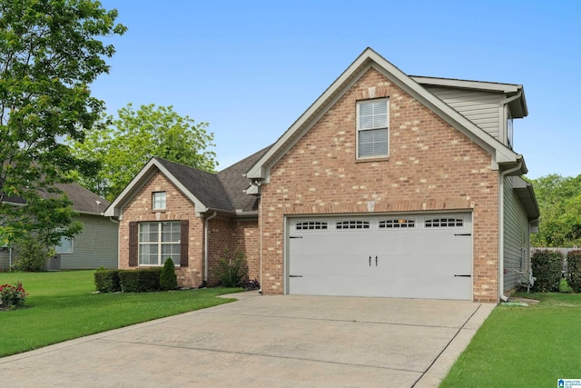 142 Falling Waters Ln, Maylene, AL 35114 - traditional-style house featuring brick siding, driveway, a front lawn, a garage, and roof with shingles