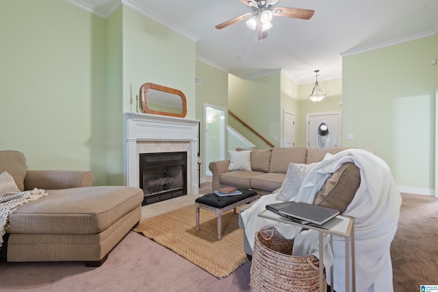 142 Falling Waters Ln, Maylene, AL 35114 - carpeted living room featuring crown molding, a ceiling fan, stairway, a tiled fireplace, and baseboards