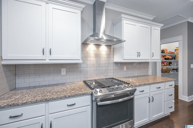 3951 Crest Lndg, Irondale, AL 35210 - kitchen featuring gas range, wall chimney exhaust hood, ornamental molding, dark wood-style floors, and tasteful backsplash
