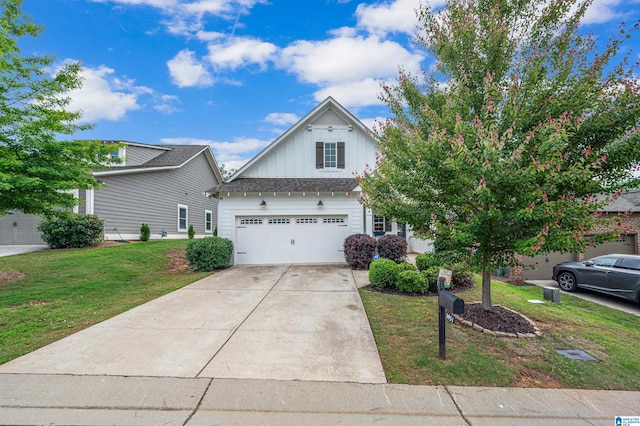 3951 Crest Lndg, Irondale, AL 35210 - view of front facade with board and batten siding, concrete driveway, a front yard, and an attached garage