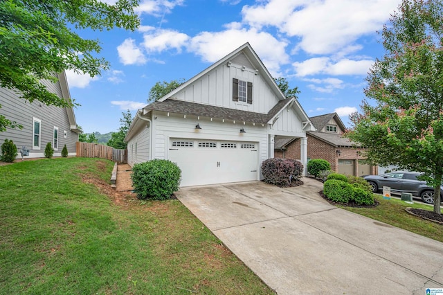 3951 Crest Lndg, Irondale, AL 35210 - view of front of house featuring board and batten siding, a garage, concrete driveway, and roof with shingles
