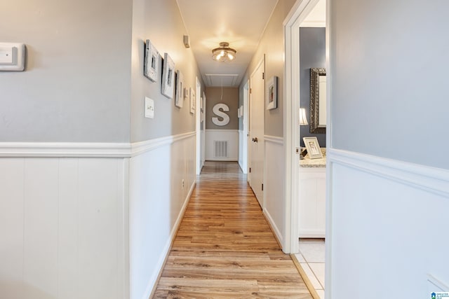 14 Shades Crest Rd, Hoover, AL 35226 - hall with attic access, light wood-type flooring, wainscoting, and a decorative wall