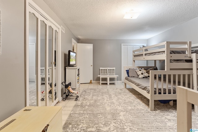 14 Shades Crest Rd, Hoover, AL 35226 - bedroom featuring a textured ceiling and light tile patterned flooring