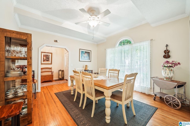 8526 Scenic Ridge Dr, Pinson, AL 35126 - dining area featuring arched walkways, crown molding, a ceiling fan, and light wood finished floors
