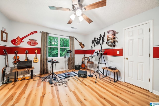 8526 Scenic Ridge Dr, Pinson, AL 35126 - workout room featuring wood finished floors, a ceiling fan, baseboards, and a textured ceiling