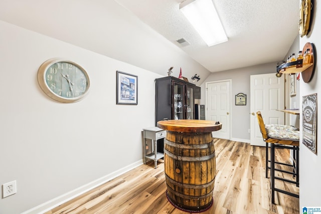 8526 Scenic Ridge Dr, Pinson, AL 35126 - bar area featuring light wood finished floors, baseboards, and a textured ceiling