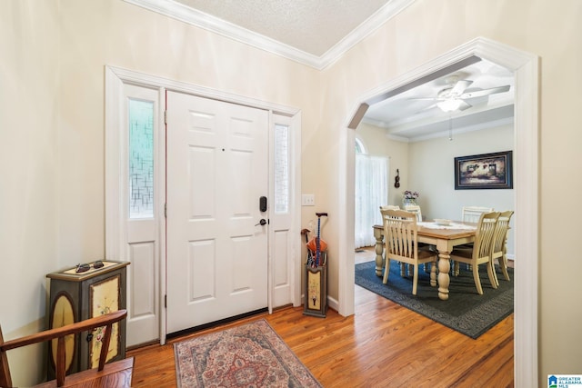 8526 Scenic Ridge Dr, Pinson, AL 35126 - entryway featuring crown molding, light wood-style flooring, arched walkways, ceiling fan, and baseboards