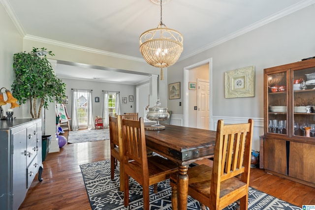 1051 Oak Meadows Rd, Birmingham, AL 35242 - dining space with crown molding, dark wood finished floors, a chandelier, and a wainscoted wall