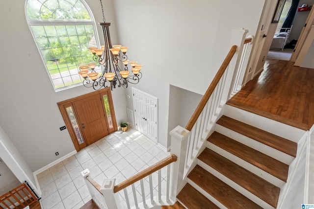 1051 Oak Meadows Rd, Birmingham, AL 35242 - entryway featuring a high ceiling, a chandelier, baseboards, stairs, and tile patterned flooring