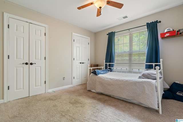 1051 Oak Meadows Rd, Birmingham, AL 35242 - bedroom with multiple closets, carpet, baseboards, and a ceiling fan
