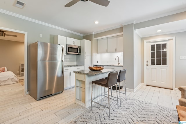 1051 Oak Meadows Rd, Birmingham, AL 35242 - kitchen with appliances with stainless steel finishes, a breakfast bar, a sink, stone counters, and tasteful backsplash