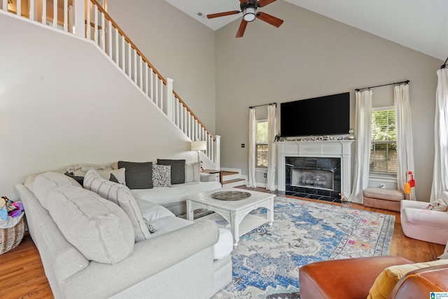 1051 Oak Meadows Rd, Birmingham, AL 35242 - living room featuring a ceiling fan, high vaulted ceiling, stairs, wood finished floors, and a tiled fireplace