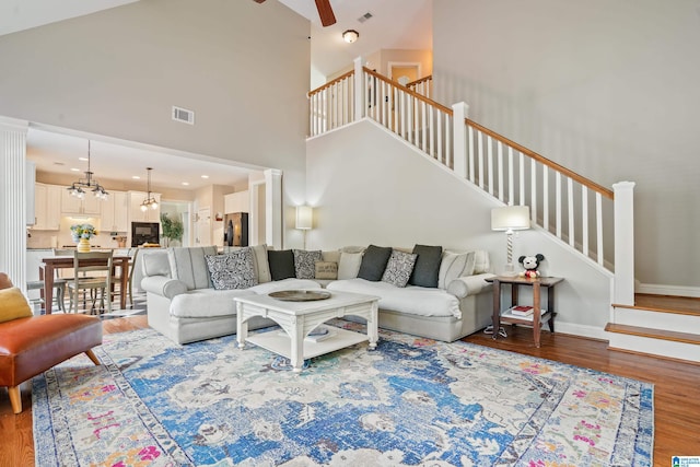 1051 Oak Meadows Rd, Birmingham, AL 35242 - living room with a ceiling fan, wood finished floors, stairway, a chandelier, and a towering ceiling