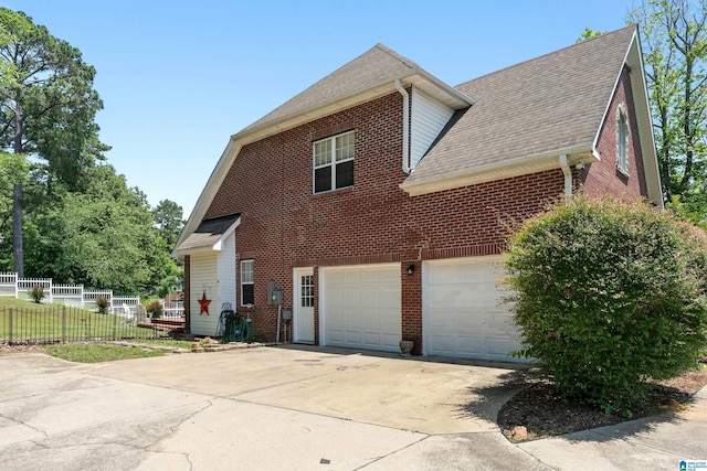 1051 Oak Meadows Rd, Birmingham, AL 35242 - view of side of home featuring roof with shingles, brick siding, driveway, and fence