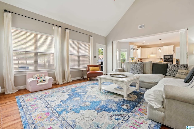1051 Oak Meadows Rd, Birmingham, AL 35242 - living room with baseboards, light wood-style floors, high vaulted ceiling, and a chandelier
