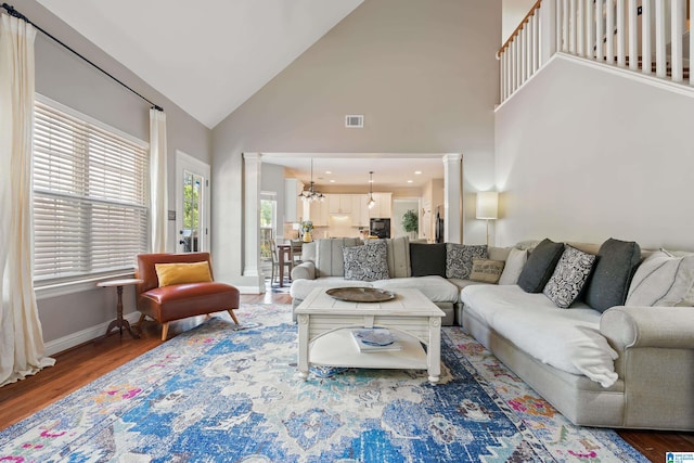 1051 Oak Meadows Rd, Birmingham, AL 35242 - living room with wood finished floors, high vaulted ceiling, ornate columns, and baseboards