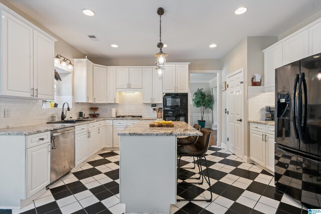 1051 Oak Meadows Rd, Birmingham, AL 35242 - kitchen featuring black appliances, a sink, a kitchen breakfast bar, white cabinets, and recessed lighting