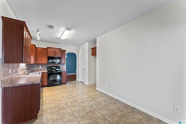 5029 Kelly Creek St, Moody, AL 35004 - kitchen featuring black appliances, arched walkways, a sink, baseboards, and backsplash