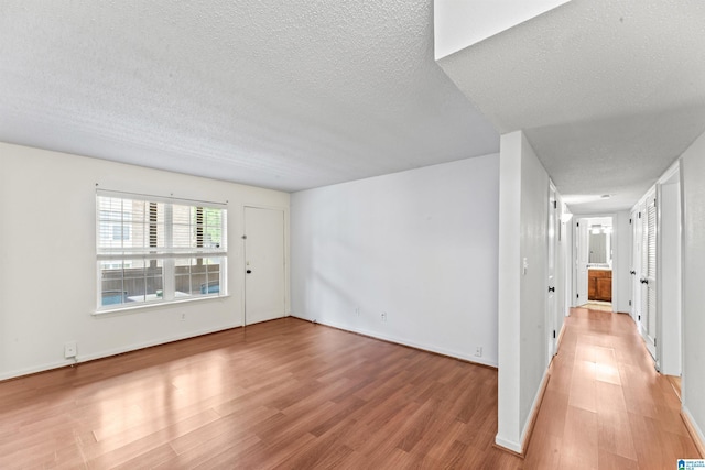 505 Patton Chapel Way Unit 505, Hoover, AL 35226 - spare room with light wood-style floors, a textured ceiling, and baseboards