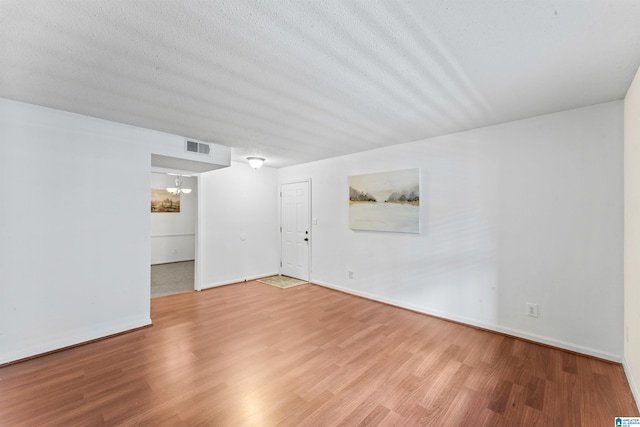 505 Patton Chapel Way Unit 505, Hoover, AL 35226 - unfurnished living room with wood finished floors, a chandelier, baseboards, and a textured ceiling