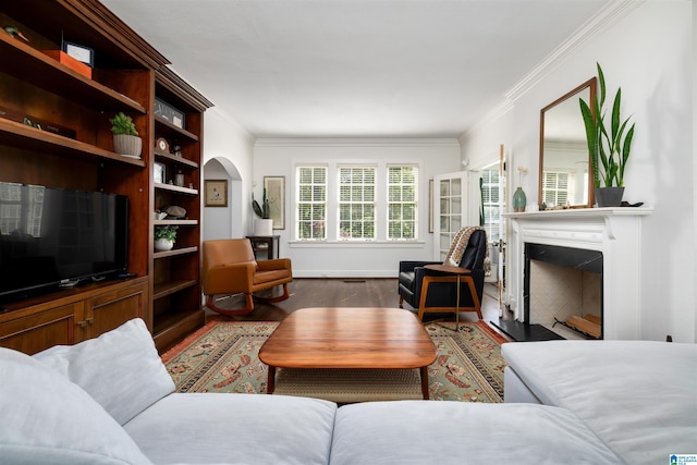 2520 Lanark Rd, Birmingham, AL 35223 - living room with ornamental molding, wood finished floors, a fireplace, and arched walkways