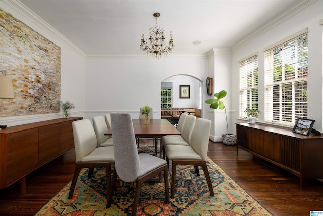 2520 Lanark Rd, Birmingham, AL 35223 - dining area with arched walkways, dark wood-style flooring, crown molding, and a chandelier