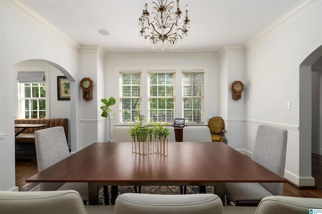 2520 Lanark Rd, Birmingham, AL 35223 - dining space featuring arched walkways, wood finished floors, plenty of natural light, and crown molding