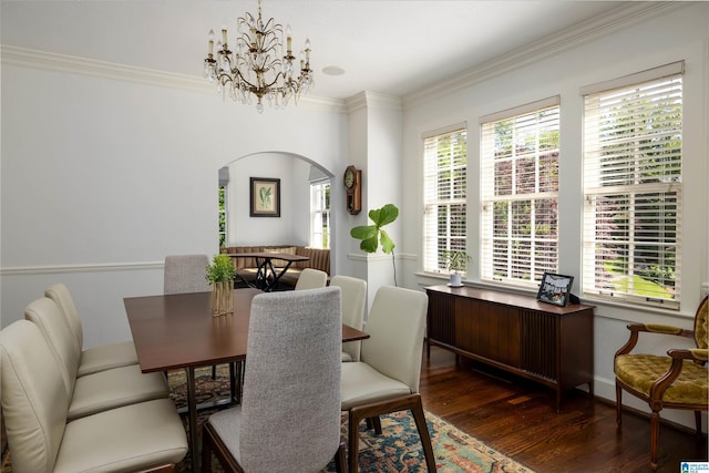 2520 Lanark Rd, Birmingham, AL 35223 - dining space with arched walkways, wood finished floors, crown molding, a chandelier, and baseboards