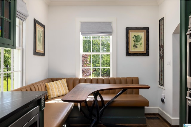 2520 Lanark Rd, Birmingham, AL 35223 - dining area featuring crown molding, dark wood-style floors, and baseboards