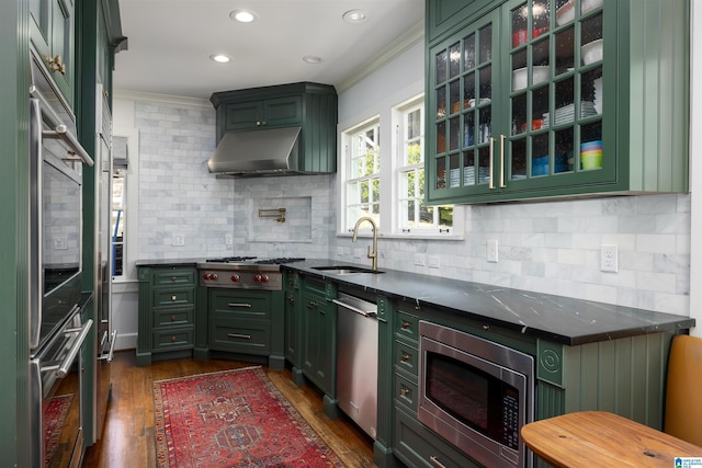 2520 Lanark Rd, Birmingham, AL 35223 - kitchen with green cabinetry, appliances with stainless steel finishes, ornamental molding, a sink, and dark wood-type flooring
