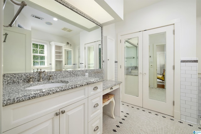 2520 Lanark Rd, Birmingham, AL 35223 - bathroom with french doors and vanity