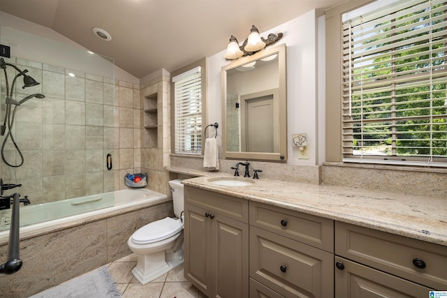 2520 Lanark Rd, Birmingham, AL 35223 - full bath with tile patterned flooring, vaulted ceiling, tiled shower / bath, toilet, and vanity