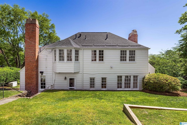 2520 Lanark Rd, Birmingham, AL 35223 - back of house with a chimney, a yard, and a shingled roof