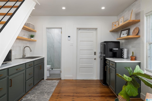 2520 Lanark Rd, Birmingham, AL 35223 - kitchen with open shelves, a sink, freestanding refrigerator, tasteful backsplash, and dark wood-style flooring