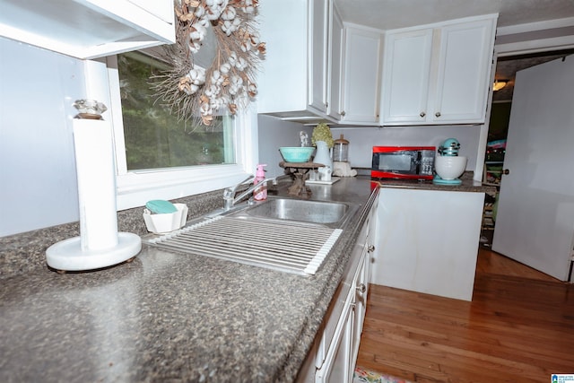 1619 Websters Chapel Rd, Wellington, AL 36279 - kitchen featuring white cabinetry, dark countertops, and a sink