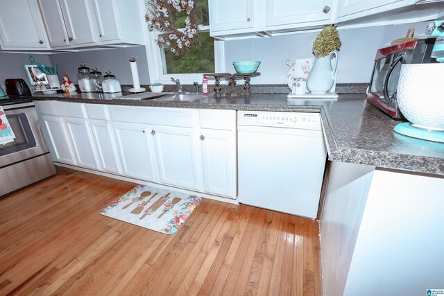 1619 Websters Chapel Rd, Wellington, AL 36279 - kitchen featuring white dishwasher, electric range, white cabinets, dark countertops, and light wood finished floors
